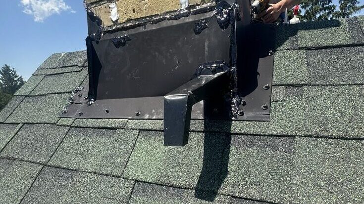 Custom aluminum bat excluder installed at a chimney bat entry point during a professional bat removal and bat-proofing project. The one-way device allows bats to leave safely while preventing them from re-entering the home.