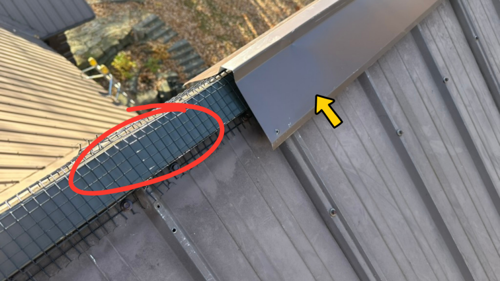 Custom aluminum flashing, bat-proof screening, and decorative ridge cap installed on a metal roof ridge vent to prevent bats from entering the attic while maintaining ventilation.
