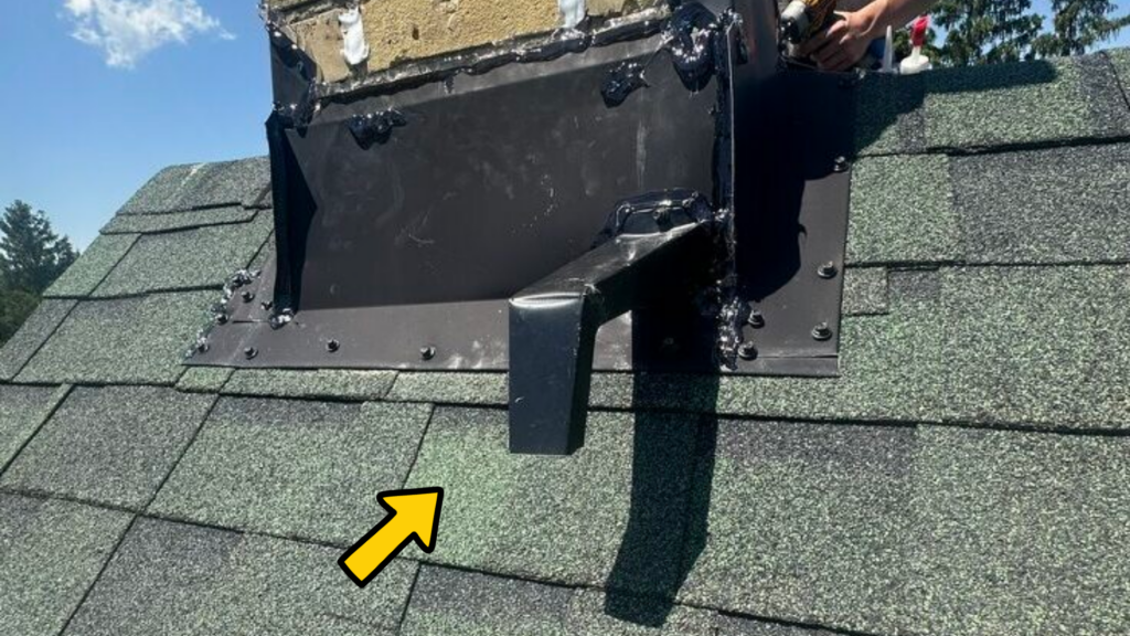 Bat excluder installed at the base of a chimney where bats were entering through gaps in the chimney flashing.