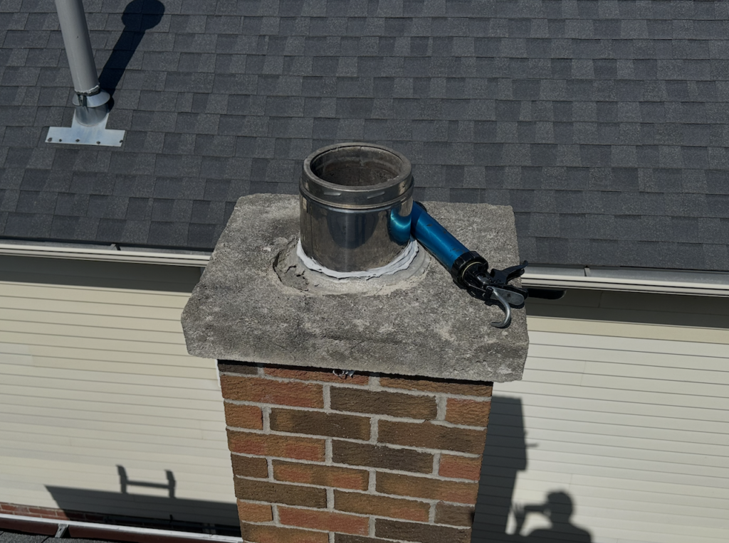 Deteriorating chimney cap with open flue that can allow bats, rats, and other animals to enter