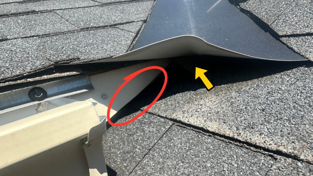 Gap under raised roof flashing where bats can enter.