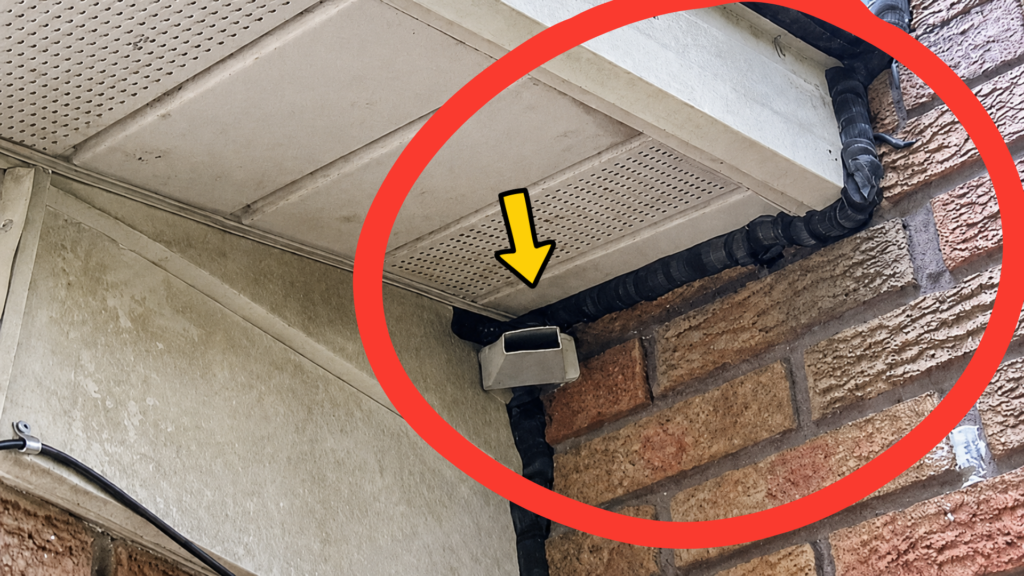 Alt text: Custom bat excluder installed at a soffit and brick corner with surrounding gaps sealed during professional bat-proofing.