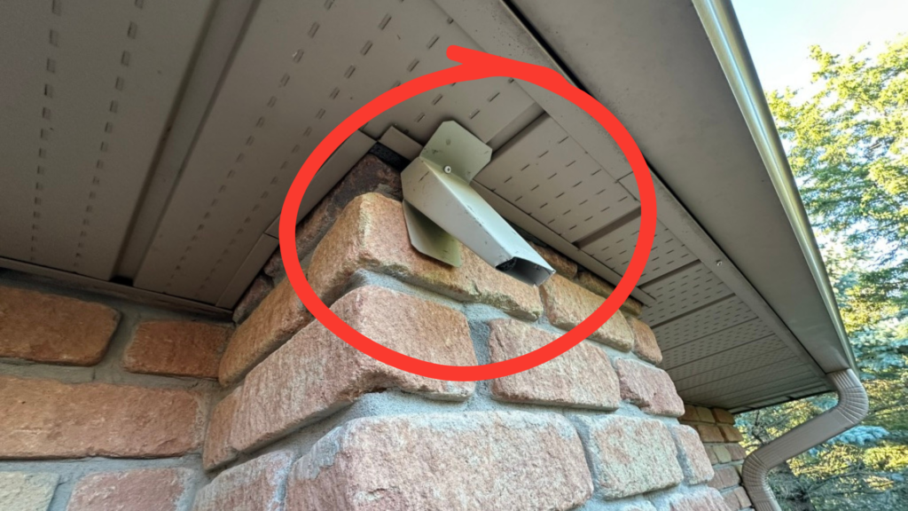 Custom bat excluder positioned over the main soffit-to-brick entry point before caulking