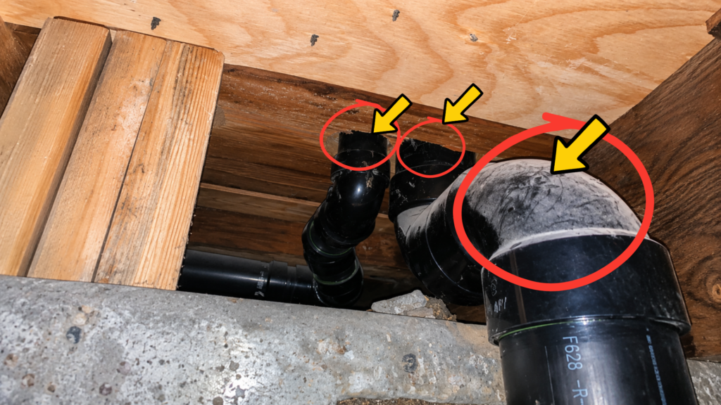 Scratches and disturbed dust on a black basement plumbing pipe caused by bats repeatedly brushing against it while travelling through a ceiling gap.