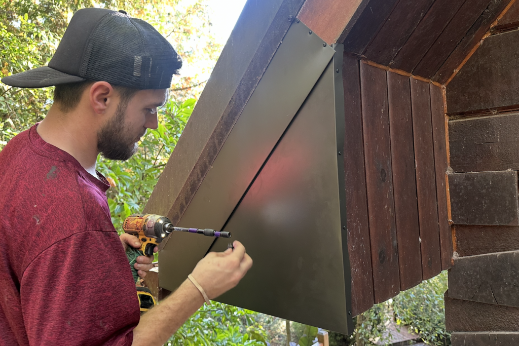 Custom metal flashing installed over rotted fascia soffit and siding to keep bats and rain out