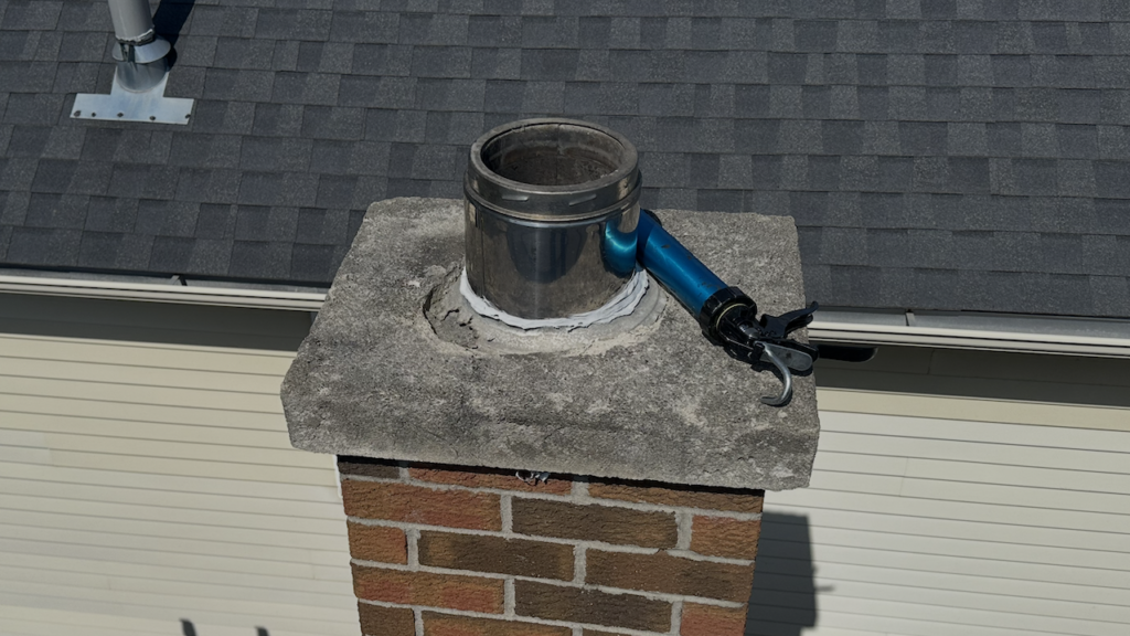Deteriorating chimney cap with open flue that can allow bats, rats, and other animals to enter